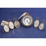 A brass and glass ball clock with white and blue enamel dial,
