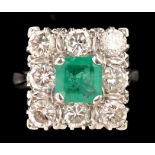 An emerald and diamond cluster ring, the central square cut emerald measuring approximately 7 x 7mm,