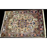 A Jozan mat, the floral rosette surrounded by foliate scrolls on ivory ground, 90 x 53cms.