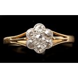 A diamond cluster ring, the seven old cut diamonds weighing a total of approximately 0.