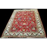 A Tabriz carpet, the claret ground with full bold floral design, 340 x 236cms.