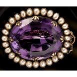 An Victorian amethyst and half pearl brooch, the oval and facet cut amethyst measuring 28 x 22 x 11.