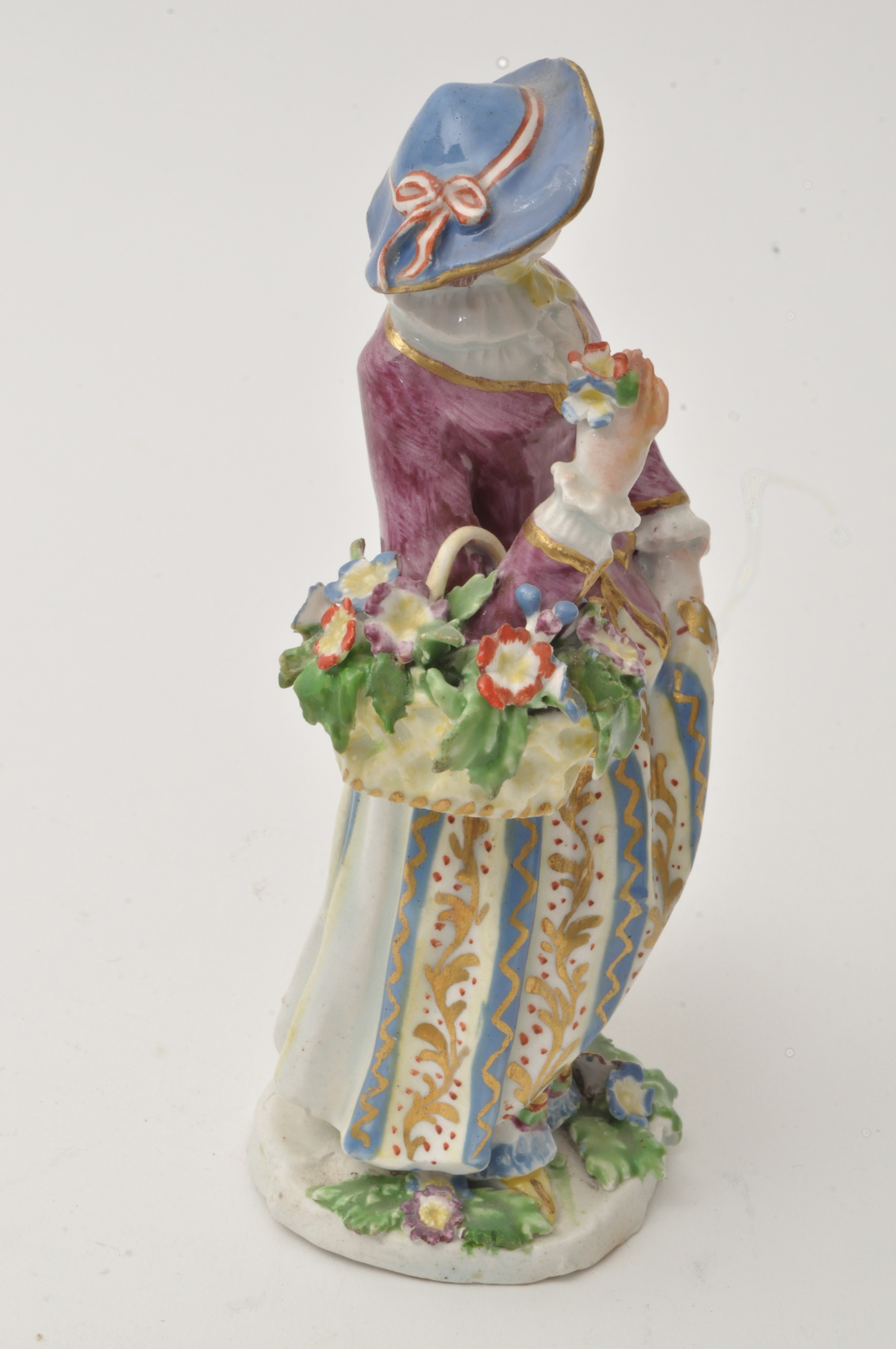 Bow figure of a flower girl, standing holding a basket of flowers over her right arm, - Image 6 of 12