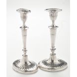 A pair of Edward VII silver candlesticks, by William Hutton & Sons Ltd.