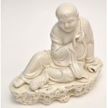 Chinese 'Dehua' figure of Budha Maitreya, seated with joyful expression turned towards a toad,