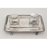 A George V silver inkwell and pen tray, by S.W. Smith & Co., Birmingham 1914, 19cms, 6.6oz.