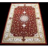 A woven 'Bamboo Silk' rug, the central medallion surrounded by foliate scrolls on red ground,