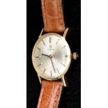 Omega: a lady's 9ct. gold cased wristwatch, circular silvered baton dial, leather strap.