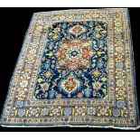 A Tabriz rug, the central foliate medallion surrounded by floral motifs on blue ground,