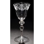 Engraved light baluster goblet of 'Newcastle' type, slightly flaring round funnel bowl,