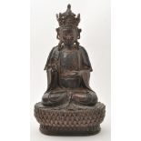 Lacquered bronze figure of a Buddhist deity, seated in dhyanasana with right hand raised in mudra,