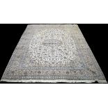 A Persian Kashan carpet, the central rosette on ivory ground surrounded by foliate scrolls,