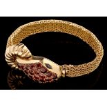 A yellow metal, garnet and sapphire watch bracelet of snake form,