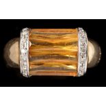 A citrine and diamond dress ring, the scissor cut citrine in barrel form collet mount,