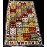 A Qashqai rug, with panels of leaf decoration surrounded by butterfly pattern border, 209 x 111cms.