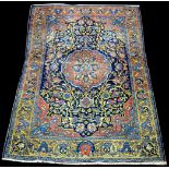 A Bidjar rug, the floral medallion surrounded by bold foliate scrolling design on blue ground,