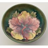 Moorcroft 'Hibiscus' shallow bowl, interior with single flowerhead in mauve, green and yellow,