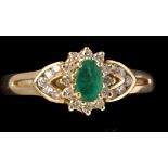 An emerald and diamond cluster ring, the oval facet cut emerald measuring approximately, 5.2 x 3.