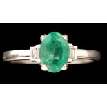 An emerald and diamond ring, the oval facet cut emerald measuring 7.8 x 5.