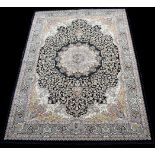 A woven 'Bamboo Silk' rug, with central rosette surrounded by foliate design on dark blue ground,