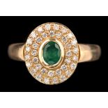 An emerald and diamond cluster ring,