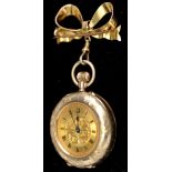 A 9ct. gold lady's fob watch, with gilt roman dial, the case with sunburst pattern, with 9ct.