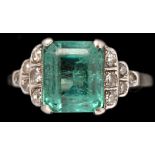 An Art Deco emerald and diamond ring, the emerald measuring 9.6 x 8 x 6.