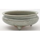 Celadon tripod censer, of squat form, with cloud scrolls between combed meander, diameter 26.5cm.