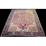 A Heriz carpet, decorated with a bold geometric floral pattern, 344 x 246cms.