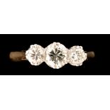 A three stone diamond ring, the central brilliant cut diamond weighing approximately 0.