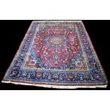 A Khorassan carpet, the central rosette on claret ground surrounded by foliate scrolls,