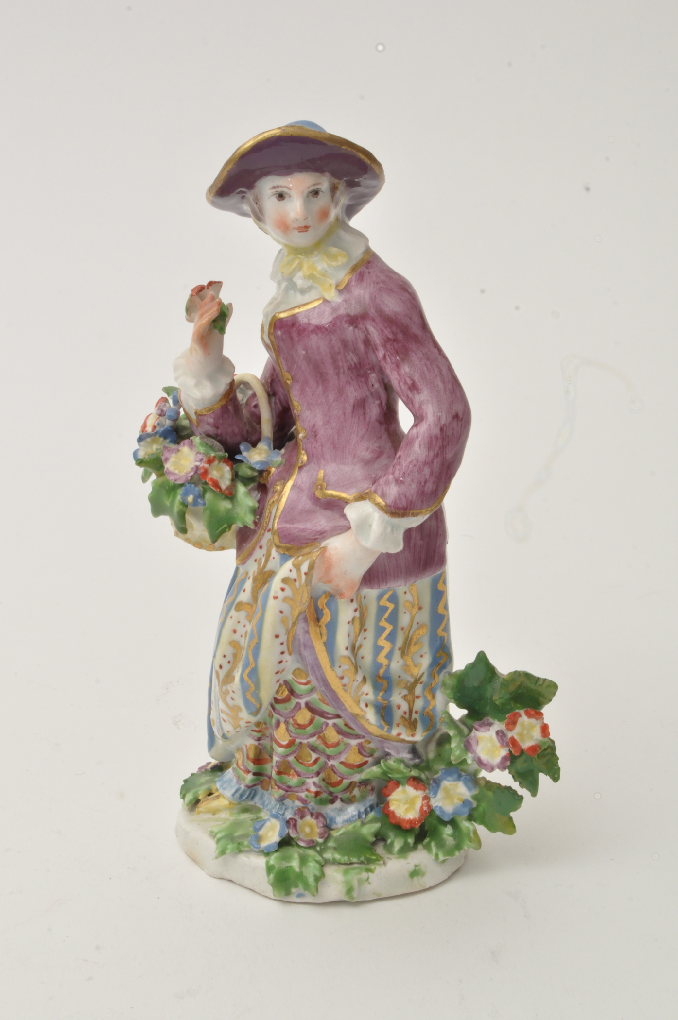 Bow figure of a flower girl, standing holding a basket of flowers over her right arm, - Image 3 of 12