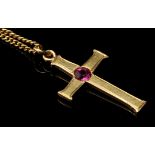 A ruby and yellow metal crucifix pattern pendant, centred with a Burmese ruby,