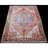 A Heriz carpet, with bold floral geometric design, 318 x 223cms.