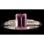 A pink sapphire and diamond ring, the rectangular facet cut pink sapphire weighing approximately 1.