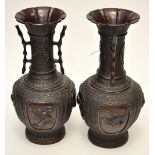 Pair of Japanese bronze vases, slight pear shaped bodies rising to elongated trumpet form necks,