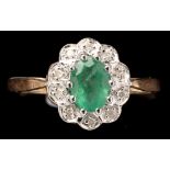 An emerald and diamond cluster ring,