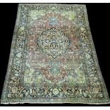 An Isfahan rug, the central foliate medallion on full floral scrolling design with red ground,