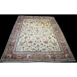 A Tabriz carpet, with loose scrolling foliate design interspersed by birds on ivory ground,