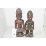Yoruba Ibeji carved wooden male and female figures.
