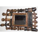 An African tribal carved wooden framed mirror.