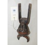 A West African guro carved wooden heddle pulley with bovine mask, 20cms.