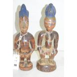 Yoruba carved wooden Ibeji figures, Reckitts blue remains.