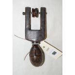 A West African guro carved wooden pulley with wheel, 16.5cms.