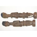 West African tribal carved wooden male and female figures with bluing to coisseres, tallest 59cms.