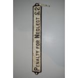 A railway cast iron 'Penalty for Neglect £2" plate, 52cms wide.