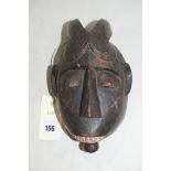 A West African baule 'Kpan Pre' mask, 21cms.