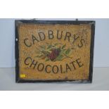 A Cadburys chocolate tin advertising sign, by Sutton Sharpe & Co., framed, 38 x 31cms.