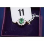 An emerald and diamond cluster ring,