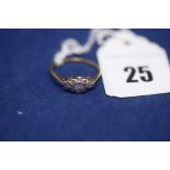 A diamond ring on yellow metal shank stamped, '18ct. Plat', ring size J, 1.7grms gross.